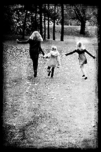 Textured high contrast image of girls running through a park