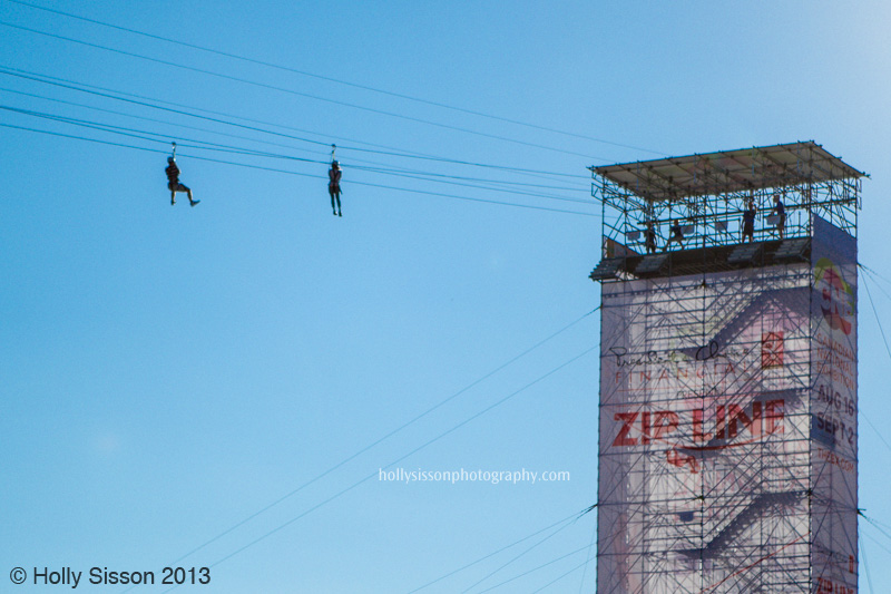 CNE ZIp Line Rider Against Blue Sky