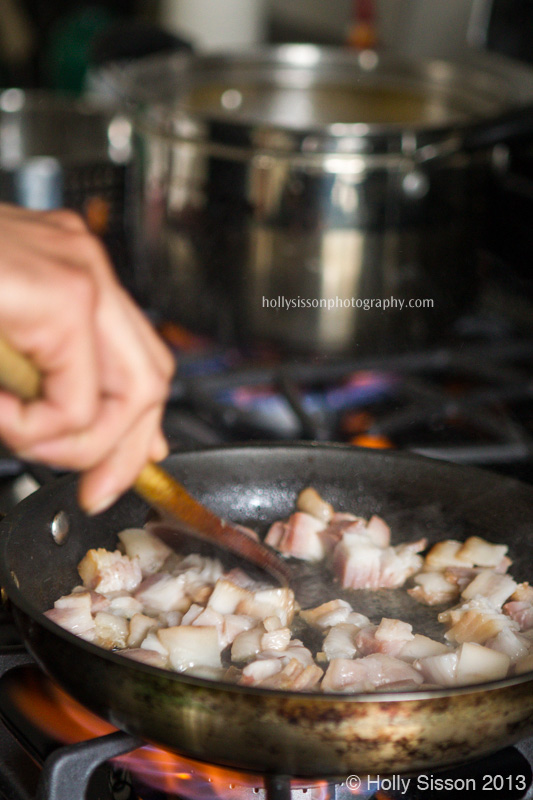 Chef Frying up Bacon on Stove