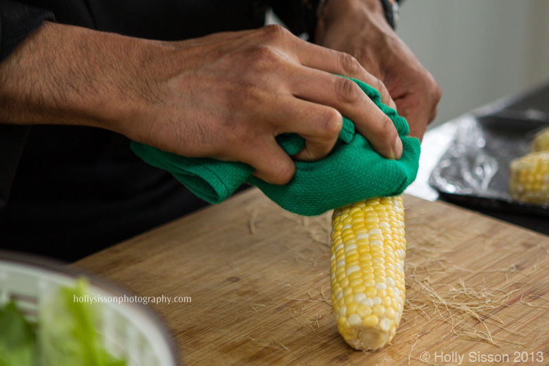 Chef Using Cloth to Remove Corn Silk